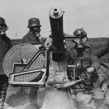 Archives of Khazad-Dum | Unknown author - 1915-1918. Photograph of German soldiers wearing gas-masks, manning a light anti-aircraft gun. The gun is the Maxim Flak M14, a version of the 37-mm Maxim-Nordenfelt gun